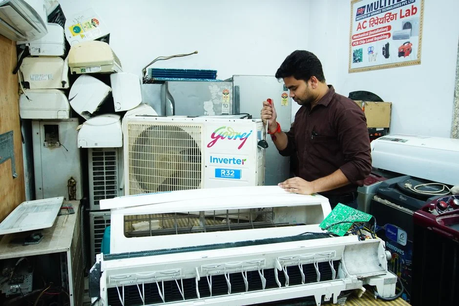 technician cleaning AC with drain bag