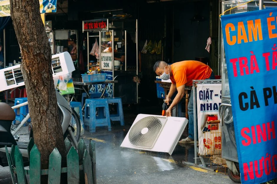 technician servicing air conditioner